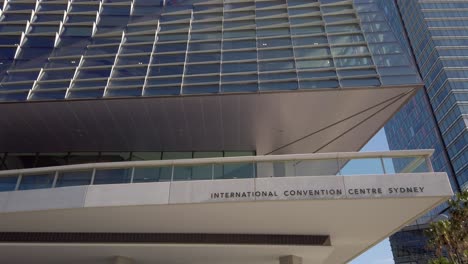 Slow-tilting-up-of-International-Convention-Centre-Sydney-building-at-Darling-Harbour,-Australia