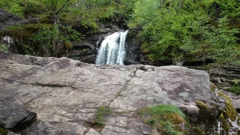 Revealing-drone-shot-of-mountain-waterfall