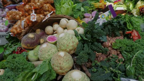 Slow-pan-R-L-and-up-across-a-variety-of-fresh-vegetables-on-display-at-a-market-stall-in-Southwark,-London