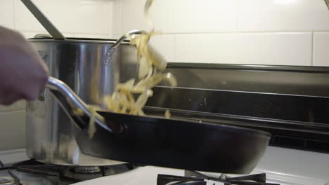 Slow-motion-flipping-of-onions-in-a-pan