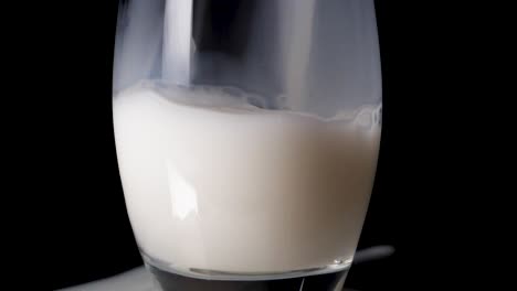 Close-up-shot-of-pouring-vegan-rice-milk-in-a-glas-in-slow-motion