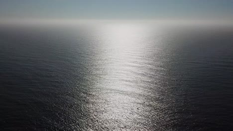 Aerial-Shot-Of-Ocean-in-suns-reflection