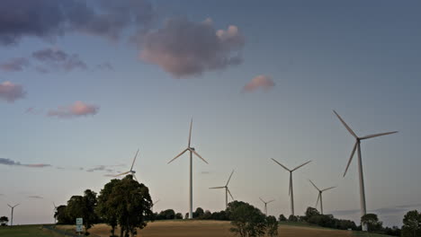 Group-of-wind-turbines-in-front-of-a-slightly-cloudy-sky-at-dawn