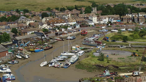 Aerial-view-of-Queenborough-on-the-Isle-Of-Sheppey,-Kent,-UK-with-a-pan-down-reveal-of-the-lock-in-the-marina