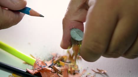 Footage-of-hands-slowly-sharpening-a-pencil-and-some-coloured-pencils-with-a-Wedge-Pencil-Sharpener