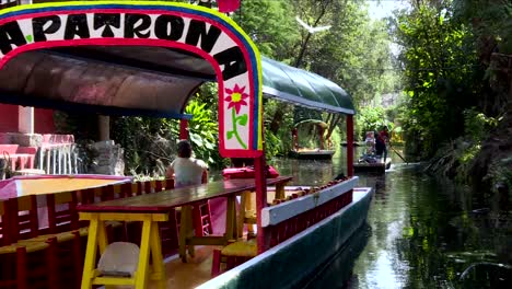 riding-over-a-traditional-boat-trajinera-in-Xochimilco,-Mexico
