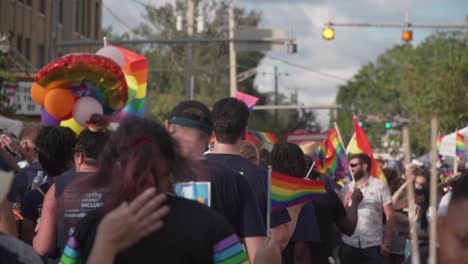 People-Marching-in-Street-With-Pride-Flags-at-River-City-Pride-Parade-in-Jacksonville,-FL