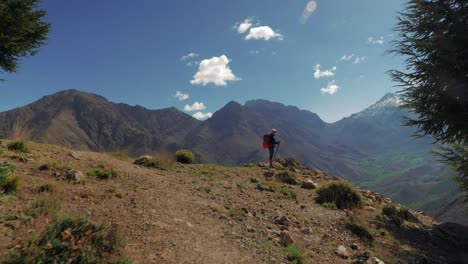 Backpacker-girl-in-High-Atlas-mountains,-Morocco,-follow-shot