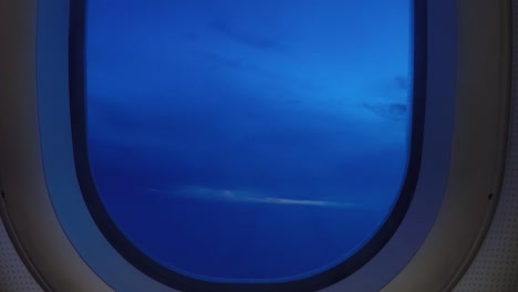 Timelapse-airplane-window-view-pacific-ocean-view-clouds-and-sunrise