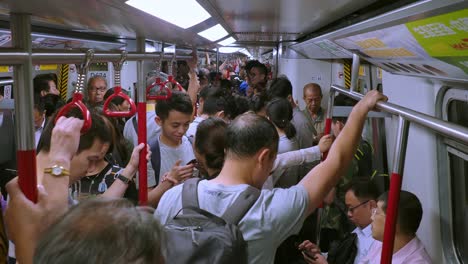 Commuters-on-a-crowded-Mass-Transit-Railway-or-MRT-train-on-the-Hong-Kong-underground-transport-network
