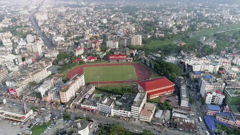 Aerial-view-of-football-pitch-close-to-railway-and-city-park-surrounded-by-residential-buildings