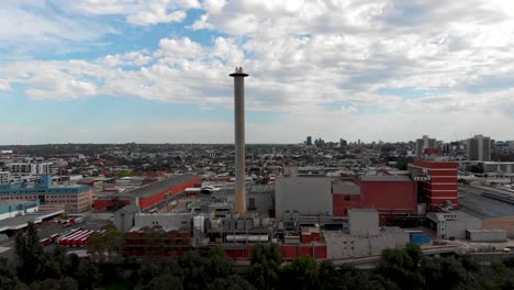Drone-Flying-Past-Forest-Revealing-Melbourne-City-Factories