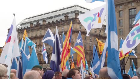 A-slow-motion-and-close-up-of-a-crowd-shot-of-people-with-flags-in-the-background