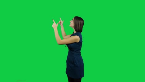 Happy-excited-girl-pointing-promoting-in-front-of-the-green-screen