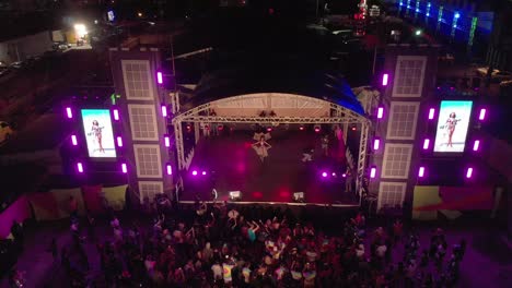 Aerial-view-of-carnival-costumes-on-a-stage-with-fog-and-lighting-techin-the-foreground