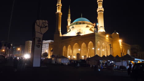 Fist-sculpture-with-revolt-written-on-it-in-front-of-Mohammad-Al-Amin-mosque-during-Lebanon-revolution
