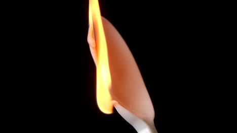 Flame-burns-isolated-plastic-spoon-against-black-background