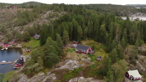 Archipelago-in-Sweden-with-traditional-red-cabins,-aerial-view