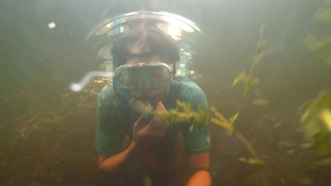 Free-diving-swimming-through-weeds-on-river