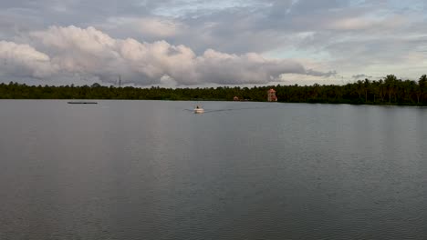 Beautiful-aerial-shot-of-a-backwater-Vembanadu-Lake,water-lines,twilight-sunset-,water-transportation,clouds