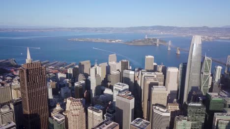 San-francisco-downtown-city-Aerial-drone-rotate-right-overlooking-the-bay-bridge,-treasure-island-and-ocean-part-two