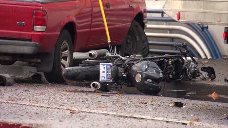 Tow-truck-cleaning-up-aftermath-of-a-red-pickup-truck-that-crashed-into-a-motorcycle