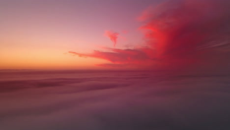 Dramatic-golden-red-evening-vanilla-sky-above-the-clouds-in-an-ocean-of-sky
