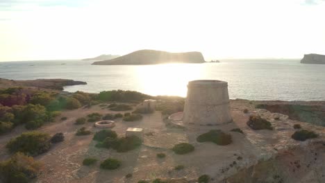 Sunset-aerial-view-of-pirate-lookout-tower-in-Ibiza