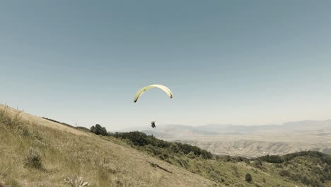 Paraglider-starts-flying-from-a-top-of-a-mountain