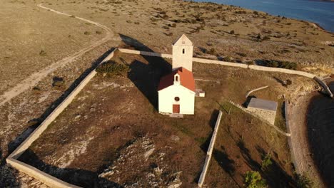 Beautiful-traditional-small-island-church-in-the-Adriatic,-aerial-view-approaching