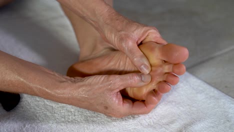 Extreme-closeup-of-mature-woman-massaging-her-foot-with-her-hands