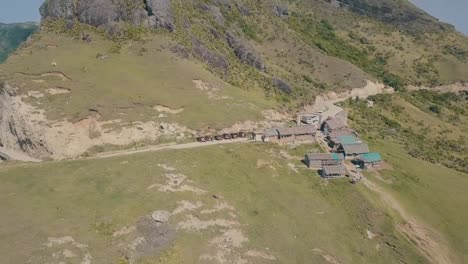Cinematic-aerial-drone-video-of-splashing-ocean-waves-into-a-scenic-mountains-of-Sabtang,-Batanes-in-the-Philippines