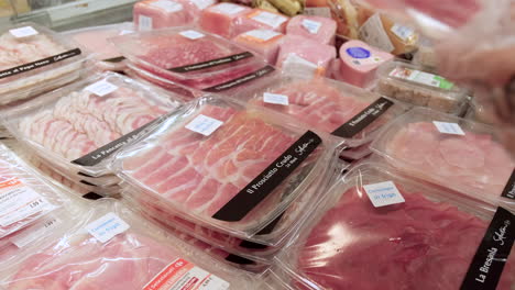 Choosing-ham-from-a-selection-at-market
