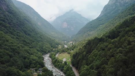 Lush-Exotic-Green-Mountain-Valley-Road-in-Valle-Verzasca,-Switzerland---Aerial-Drone