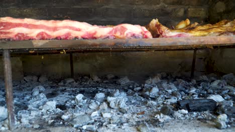 Charcoiled-beef-meat-roasting-slowly-in-a-traditional-asado,-Argentina