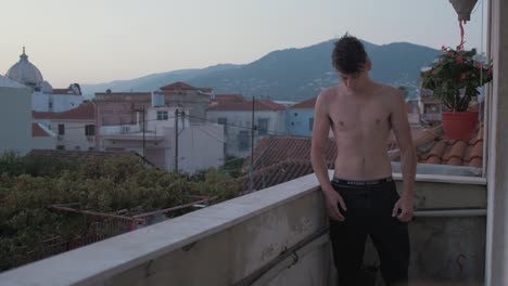 Fit-lean-athletic-young-man-early-morning-balcony
