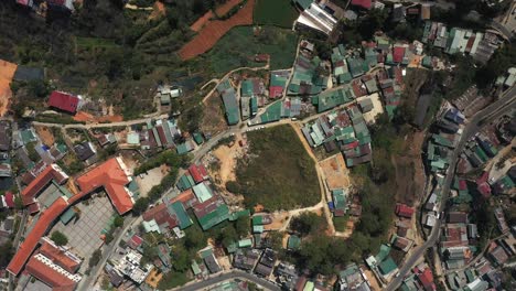 Top-down-drone-shot-of-buildings,-landscaping-near-the-city-of-Da-Lat-or-Dalat-in-the-Central-Highlands-of-Vietnam-on-sunny-day