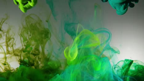 Colorful-cloud-swirls-of-olive-green-acrylic-dye-ink-falling-slowly-into-water,-prismatic-multi-color-overload-and-very-mesmerizing-footage