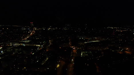 Flying-over-city-lights-in-dark-night