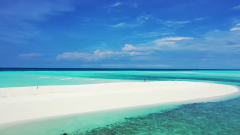 Paradise-exotic-white-sandy-beach-bend-surrounded-by-calm-clear-water-of-turquoise-lagoon-with-coral-reef-in-Maldives