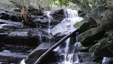 Somersby-falls-near-Sydney-Australia-with-mossy-rocks-and-vegetation-in-Brisbane-Water-National-Park,-Locked-shot
