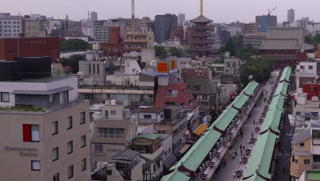 Slow-tilt-up-pan-over-Senso-ji-Shrine-and-approach-in-Asakusa,-Tokyo-on-bright-day