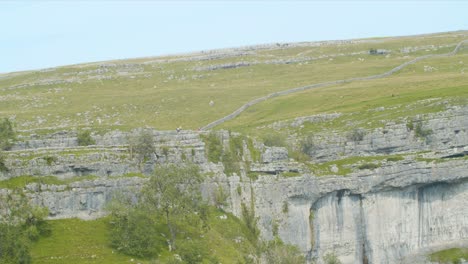 Static-shot-of-walkers-on-Malham-Cove,-North-Yorkshire,-England