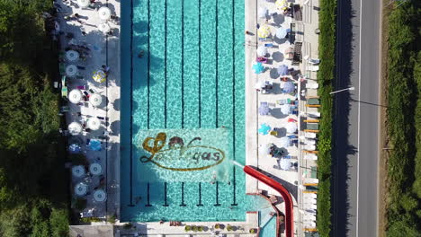 Swimming-pool-with-few-people-enjoying-the-sun-due-to-the-Coronavirus-pandemic