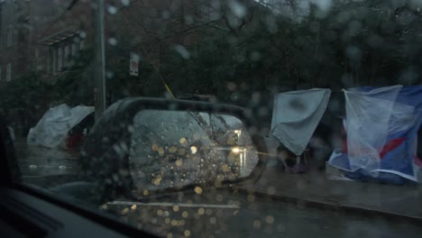 homeless-tents-in-rear-view-mirror-rain-downtown-atlanta-slow-motion