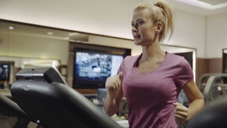 Active-Woman-Running-On-A-Treadmill-At-The-Gym---medium-shot,-slow-motion