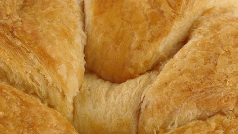 Macro-close-up-of-croissant,-texture-and-shape-is-visible-as-the-pastry-rotates