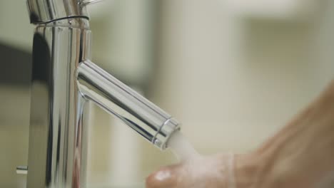 Hygiene---Washing-Hands-On-A-Running-Water-Under-The-Stainless-And-Modern-Faucet-At-Home