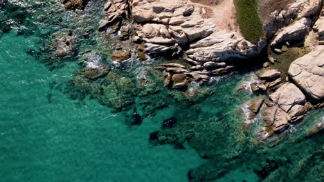 Steady-Aerial-drone-clip-over-a-rock-formation-in-an-exotic-beach-in-Vourvourou,-Chalkidiki,-Greece