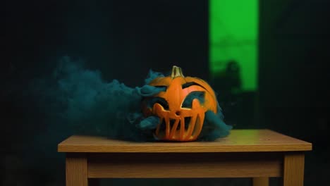 Very-thick-blue-smoke-inside-carved-pumpkin-coming-out-in-slow-motion
